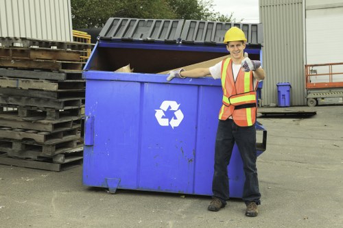 Technician preparing bins for pickup outside a Putney business premises